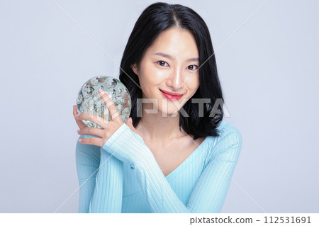 A woman holding a glass sculpture A woman holding a glass sculpture 112531691
