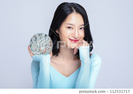 A woman holding a glass sculpture A woman holding a glass sculpture 112531717