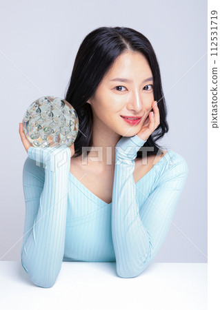 A woman holding a glass sculpture 112531719