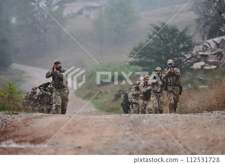 A disciplined and specialized military unit, donned in camouflage, strategically patrolling and maintaining control in a high-stakes environment, showcasing their precision, unity, and readiness for A disciplined and specialized military unit, donned in camouflage, strategically patrolling and maintaining control in a high-stakes environment, showcasing their precision, unity, and readiness for 112531728