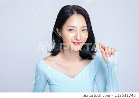 A woman holding a pill A woman holding a pill 112531748