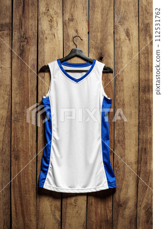 Basketball jersey on hanger against wooden background 112531762