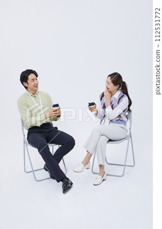 A man and a woman talking to over a cup of coffee 112531772