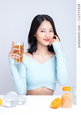 A woman holding a pill in a cup A woman holding a pill in a cup 112531826