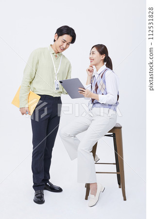A man and a woman talking to a tablet while filing 112531828