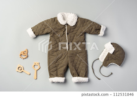 Gray quilted baby overalls for winter flat lay 112531846