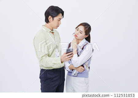 A careful of a man and woman looking at a smartphone 112531853