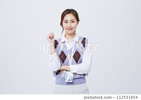 A woman who performs hand gestures with her employee ID around her neck A woman who performs hand gestures with her employee ID around her neck 112531854