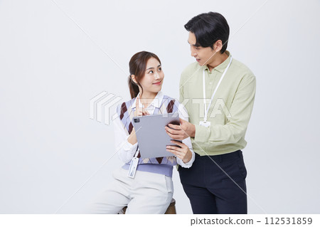 A man and woman smiling at a tablets A man and woman smiling at a tablets 112531859