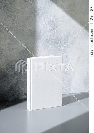 White notepad with hard cover on gray background White notepad with hard cover on gray background 112531872