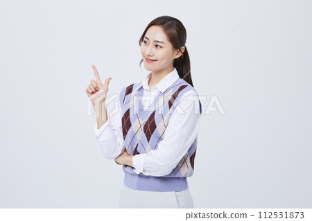 A woman who performs hand gestures with her employee ID around her neck A woman who performs hand gestures with her employee ID around her neck 112531873