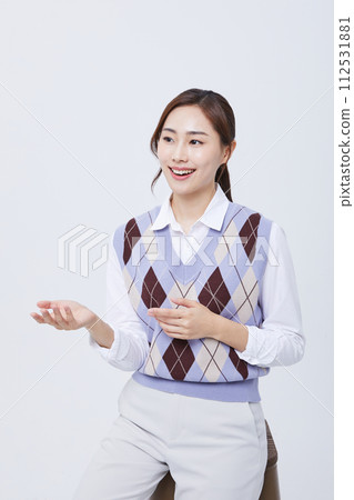A woman who explains in a chair with her employee ID around her neck 112531881