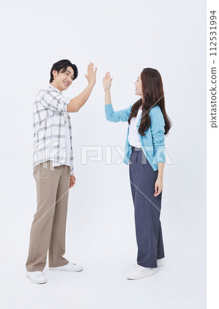 A man and a woman who high fives while preparing for a youth start up 112531994
