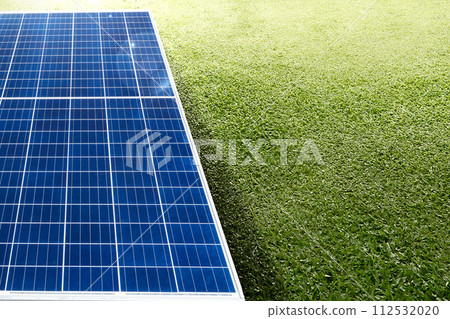 Image of solar panel with sunlight on green grass background. Image of solar panel with sunlight on green grass background. 112532020