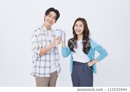 A man and a woman holding a cup of water while preparing for a youth start up 112532044