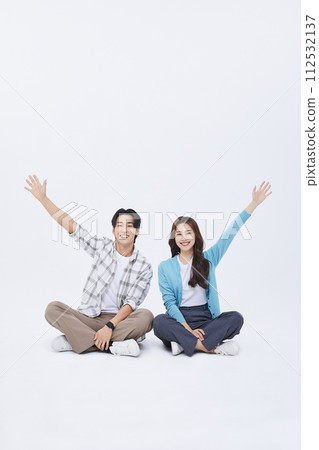 A man and a woman sitting cross legged A man and a woman sitting cross legged 112532137