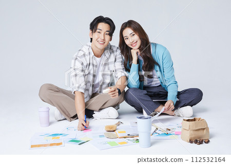 A man and a woman sitting cross legged and talking A man and a woman sitting cross legged and talking 112532164