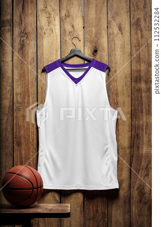 Basketball jersey on hanger against wooden background 112532284