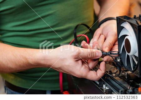 Close up of man repairing computer system unit Close up of man repairing computer system unit 112532363