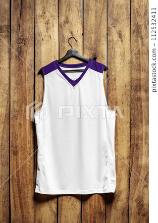 Basketball jersey on hanger against wooden background 112532411
