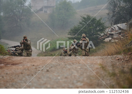 A disciplined and specialized military unit, donned in camouflage, strategically patrolling and maintaining control in a high-stakes environment, showcasing their precision, unity, and readiness for A disciplined and specialized military unit, donned in camouflage, strategically patrolling and maintaining control in a high-stakes environment, showcasing their precision, unity, and readiness for 112532436