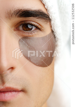 Portrait of attractive young male model with eye patches on white background 112532506