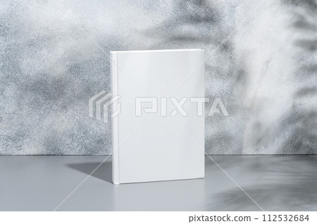 White blank book with hard cover on gray background with shadows 112532684