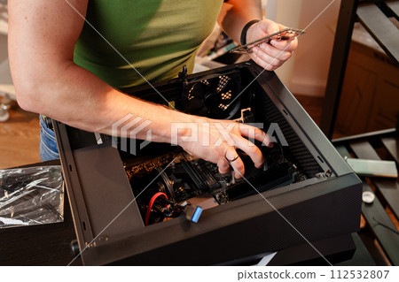 Close up of man repairing computer system unit 112532807
