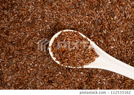 Flax seeds in a spoon macro top view 112533162