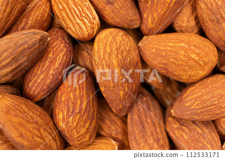 A lot of roasted nuts almond macro A lot of roasted nuts almond macro 112533171
