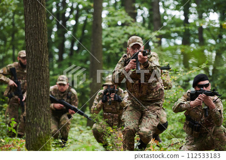 A disciplined and specialized military unit, donned in camouflage, strategically patrolling and maintaining control in a high-stakes environment, showcasing their precision, unity, and readiness for 112533183