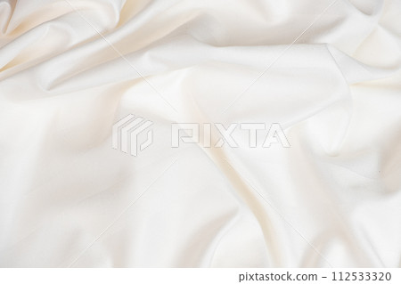 Waves and patterns of crumpled natural satin white milk color fabric. Waves and patterns of crumpled natural satin white milk color fabric. 112533320