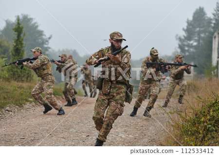 A disciplined and specialized military unit, donned in camouflage, strategically patrolling and maintaining control in a high-stakes environment, showcasing their precision, unity, and readiness for A disciplined and specialized military unit, donned in camouflage, strategically patrolling and maintaining control in a high-stakes environment, showcasing their precision, unity, and readiness for 112533412