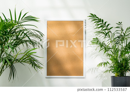 White wooden photo frame with plant leaves on white background White wooden photo frame with plant leaves on white background 112533587