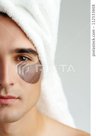 Portrait of attractive young male model with eye patches on white background Portrait of attractive young male model with eye patches on white background 112533608