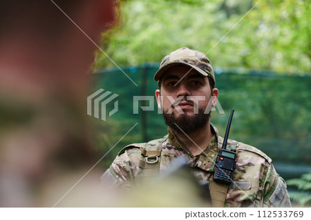Elite soldier exudes focused determination and readiness, geared up for a perilous military operation, capturing the essence of courage and professionalism in the face of imminent danger Elite soldier exudes focused determination and readiness, geared up for a perilous military operation, capturing the essence of courage and professionalism in the face of imminent danger 112533769