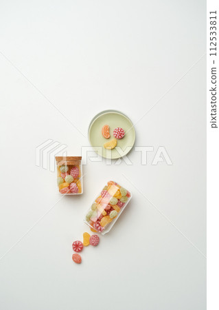 The fruit shaped candy is in a bottle 112533811
