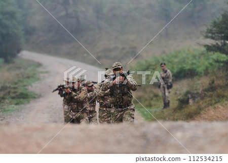 A disciplined and specialized military unit, donned in camouflage, strategically patrolling and maintaining control in a high-stakes environment, showcasing their precision, unity, and readiness for 112534215