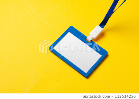 Blank nametag on a string on yellow background copy space Blank nametag on a string on yellow background copy space 112534256