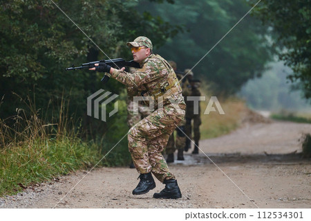 A disciplined and specialized military unit, donned in camouflage, strategically patrolling and maintaining control in a high-stakes environment, showcasing their precision, unity, and readiness for 112534301