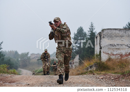 A disciplined and specialized military unit, donned in camouflage, strategically patrolling and maintaining control in a high-stakes environment, showcasing their precision, unity, and readiness for 112534318