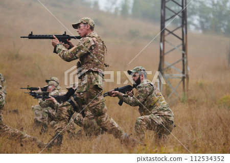 A disciplined and specialized military unit, donned in camouflage, strategically patrolling and maintaining control in a high-stakes environment, showcasing their precision, unity, and readiness for A disciplined and specialized military unit, donned in camouflage, strategically patrolling and maintaining control in a high-stakes environment, showcasing their precision, unity, and readiness for 112534352