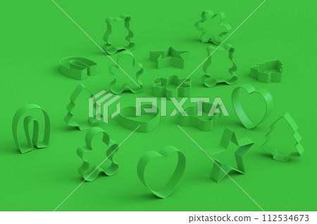 Set of metal cookie cutters for homemade Christmas biscuit on green monochrome 112534673