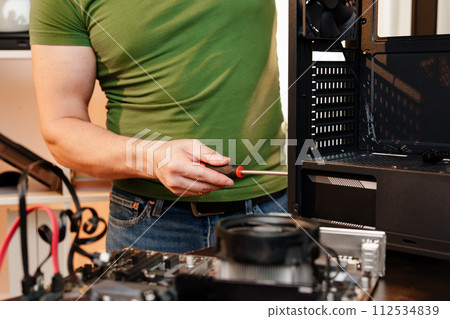 Close up of man repairing computer system unit Close up of man repairing computer system unit 112534839