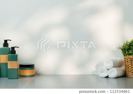 Soap dispenser and spa towels on white background in shadow 112534861