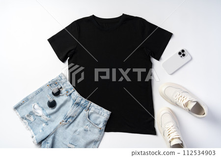 T-shirt, jeans and white sneakers on gray background top view T-shirt, jeans and white sneakers on gray background top view 112534903