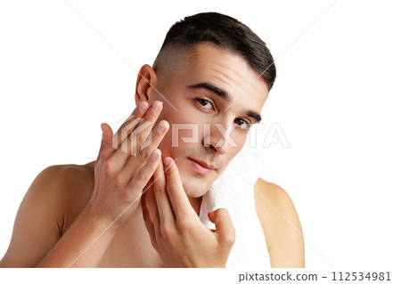 Young attractive brunet guy with perfect skin touching chin on white background 112534981