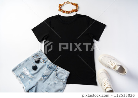 T-shirt, jeans and white sneakers on gray background top view T-shirt, jeans and white sneakers on gray background top view 112535026