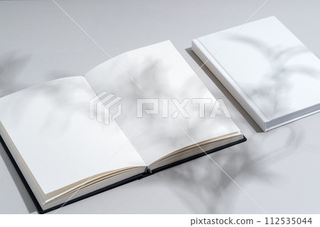 Blank open notepad on gray background studio shot Blank open notepad on gray background studio shot 112535044