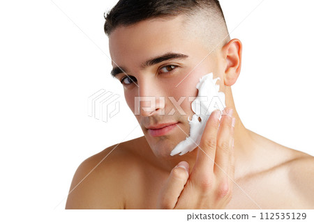 Young handsome man applying shaving foam against white background 112535129